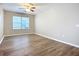 Bedroom featuring wood-look flooring, neutral paint, and a large window at 12508 Evington Point Dr, Riverview, FL 33579