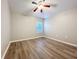 Bright bedroom with laminate floors, ceiling fan, and large window for natural light at 12508 Evington Point Dr, Riverview, FL 33579