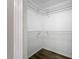 A walk-in closet with wood floors and white walls, featuring wire shelving for organization at 12508 Evington Point Dr, Riverview, FL 33579