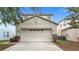 The home includes a manicured lawn, two car garage, and lovely landscaping at 12508 Evington Point Dr, Riverview, FL 33579
