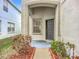 Inviting front porch with a gray door and a small window providing natural light at 12508 Evington Point Dr, Riverview, FL 33579