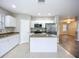Well-lit kitchen featuring white cabinets, stainless steel appliances, and granite countertops at 12508 Evington Point Dr, Riverview, FL 33579