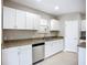 Bright kitchen with white cabinets, stainless steel appliances, and granite countertops perfect for modern cooking at 12508 Evington Point Dr, Riverview, FL 33579