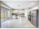 Modern kitchen features granite counters, stainless appliances, a center island, and sliding door access to the yard at 12508 Evington Point Dr, Riverview, FL 33579
