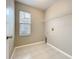 Convenient laundry room with tile flooring and a window for natural light and overhead wire shelving at 12508 Evington Point Dr, Riverview, FL 33579