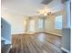 Bright, open living room with wood-look floors and large windows at 12508 Evington Point Dr, Riverview, FL 33579