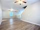 Spacious living room features wood-look flooring, ceiling fans, and an open layout at 12508 Evington Point Dr, Riverview, FL 33579