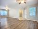 Expansive living room featuring wood floors, a ceiling fan, and multiple windows at 12508 Evington Point Dr, Riverview, FL 33579