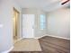 Bright living room featuring wood-look flooring and a white front door at 12508 Evington Point Dr, Riverview, FL 33579