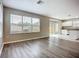 Open concept living room flows into the modern kitchen, featuring sliding glass doors to the backyard at 12508 Evington Point Dr, Riverview, FL 33579