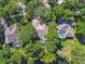 Aerial view of homes with screened pools and lush greenery in a well-maintained neighborhood with mature trees at 12523 Riverglen Dr, Riverview, FL 33569