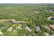 Overhead shot of homes nestled among ponds and dense trees, complete with pools and screened enclosures at 12523 Riverglen Dr, Riverview, FL 33569