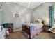 Comfortable bedroom featuring a single bed with a colorful quilt and ample storage at 12523 Riverglen Dr, Riverview, FL 33569