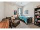 A bedroom that also functions as an office with a sofa, desk and bookshelf at 12523 Riverglen Dr, Riverview, FL 33569