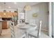 Cozy dining area with a round table, chandelier, and stainless steel appliances in the background at 12523 Riverglen Dr, Riverview, FL 33569