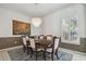 Dining room with a modern chandelier, shuttered window, and decorative wall paneling at 12523 Riverglen Dr, Riverview, FL 33569