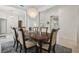 Well-lit dining area with a chandelier, open layout, and stylish decor at 12523 Riverglen Dr, Riverview, FL 33569