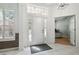 Bright foyer featuring a white front door, tile flooring, high ceilings, and a view into an office space at 12523 Riverglen Dr, Riverview, FL 33569