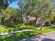 Charming home with lush landscaping, mature trees, and a well-maintained lawn, creating a picturesque setting at 12523 Riverglen Dr, Riverview, FL 33569