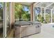Close up of a Hot Tub on the outdoor Lanai, in screened enclosure with tropical view at 12523 Riverglen Dr, Riverview, FL 33569