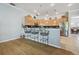 Modern kitchen with bar seating, pendant lights, and stainless steel appliances, perfect for entertaining at 12523 Riverglen Dr, Riverview, FL 33569