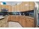 Stylish kitchen with stainless steel appliances, granite countertops, and black tiled backsplash at 12523 Riverglen Dr, Riverview, FL 33569