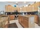 Modern kitchen with granite countertops, tile flooring, and sleek stainless steel appliances at 12523 Riverglen Dr, Riverview, FL 33569