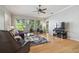 Bright living room with hardwood floors, large windows, and a view of the backyard at 12523 Riverglen Dr, Riverview, FL 33569