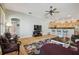 Spacious living room featuring hardwood floors, a ceiling fan, and an open layout to the kitchen at 12523 Riverglen Dr, Riverview, FL 33569