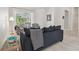 Cozy living room featuring comfortable seating, neutral tones, and a view of the outdoor patio at 12523 Riverglen Dr, Riverview, FL 33569