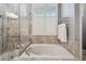 Main bathroom features a tub with tile surround and a glass enclosed shower at 12523 Riverglen Dr, Riverview, FL 33569