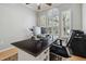 This office includes wood floors, a ceiling fan, three windows, and a large desk at 12523 Riverglen Dr, Riverview, FL 33569