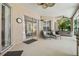 Outdoor living with lounge chairs, a hot tub and a grilling station all under a screened enclosure at 12523 Riverglen Dr, Riverview, FL 33569