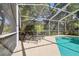 Relaxing screened-in pool area with sun loungers and beautiful tropical landscaping at 12523 Riverglen Dr, Riverview, FL 33569