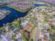 Aerial photograph shows a community pool, tennis courts, a lake, and houses with mature trees at 130 Sabal Ct # C, Oldsmar, FL 34677
