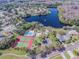 Overhead shot of community pool, tennis courts, playground, residences, and a tranquil lake setting at 130 Sabal Ct # C, Oldsmar, FL 34677