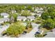 Aerial shot of condos featuring well-kept lawns, landscaping, parking, and mature tree coverage at 130 Sabal Ct # C, Oldsmar, FL 34677
