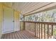 Private balcony featuring wood flooring and railing with a peaceful view of the surrounding greenery at 130 Sabal Ct # C, Oldsmar, FL 34677