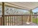 Private outdoor balcony offering a peaceful view with wood railing and floor at 130 Sabal Ct # C, Oldsmar, FL 34677