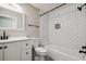 Bathroom featuring a white subway tiled shower, new white toilet, and updated vanity at 130 Sabal Ct # C, Oldsmar, FL 34677