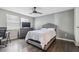 This bedroom features a ceiling fan, a dresser with a TV, and light-colored wood laminate flooring at 130 Sabal Ct # C, Oldsmar, FL 34677