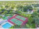 Aerial photo showcasing community amenities with pool, tennis and basketball courts surrounded by trees at 130 Sabal Ct # C, Oldsmar, FL 34677