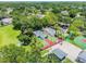 Aerial view of community center with tennis, basketball, and racquetball courts surrounded by lush greenery and mature trees at 130 Sabal Ct # C, Oldsmar, FL 34677