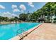 Large community pool with lounge chairs and landscaped surroundings on a sunny day at 130 Sabal Ct # C, Oldsmar, FL 34677