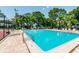Spacious community pool with lounge chairs for relaxing in a tranquil setting at 130 Sabal Ct # C, Oldsmar, FL 34677