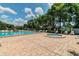 Community pool and hot tub area with ample seating surrounded by lush landscaping at 130 Sabal Ct # C, Oldsmar, FL 34677