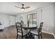 Stylish dining area featuring a ceiling fan, wood floors, and a sliding glass door for natural light at 130 Sabal Ct # C, Oldsmar, FL 34677