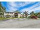 Apartment building with parking area, mature landscaping, and private balconies at 130 Sabal Ct # C, Oldsmar, FL 34677