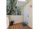 Inviting front door entrance with covered wooden porch, a potted plant, and exterior light fixture at 130 Sabal Ct # C, Oldsmar, FL 34677
