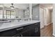 Open kitchen pass-through boasts sleek countertops, backsplash, and flows to the adjacent living area, offering style and functionality at 130 Sabal Ct # C, Oldsmar, FL 34677